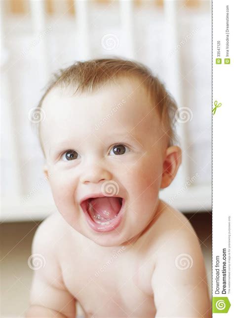 Funny Laughing Baby Against White Bed Stock Photo Image