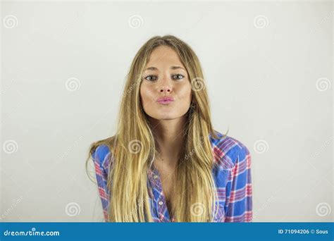 Close Up Portrait Of Beautiful Blonde Woman Making A Kissy Face Stock