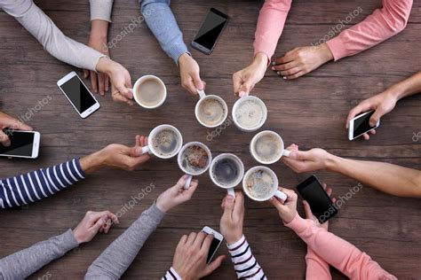 Group Of People Drinking Coffee Together Stock Photo By ©belchonock
