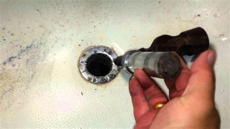 It is a long piece of flat plastic that has little barbs on the sides to catch. How to remove a broken or damaged tub drain - YouTube
