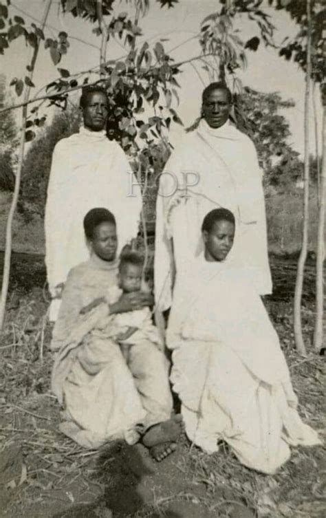 An Old Black And White Photo Of Three Women With Two Children In Front