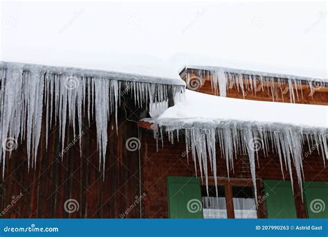 Many Large Dangerous Icicles On A House Roof In Winter Stock Image