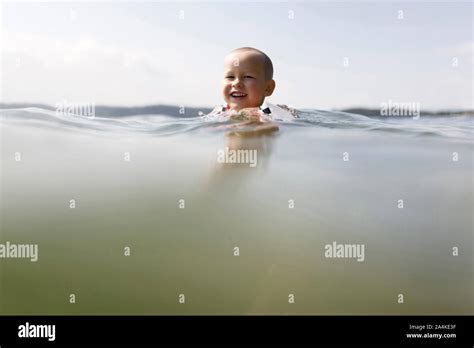 Toddler Boy Swimming With Floaties Stock Photo Alamy
