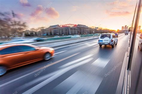 Car Driving On Freeway At Sunset Motion Blur — Stock Photo © 06photo