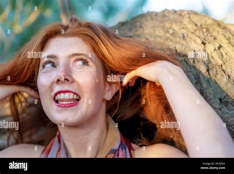 sensual seductive portrait of happy laughing beautiful red haired redhead woman with freckles