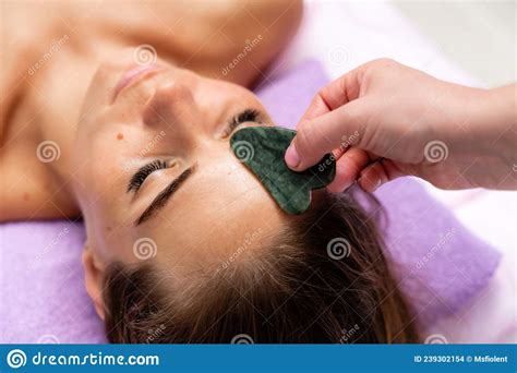 Relaxing Massage European Woman Getting Quartz Guache Face Massage In