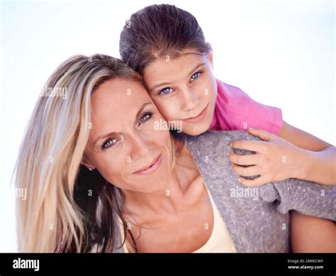 Their Bond Is Undeniable A Smiling Mother With Her Daughter On Her Back While Outdoors Stock