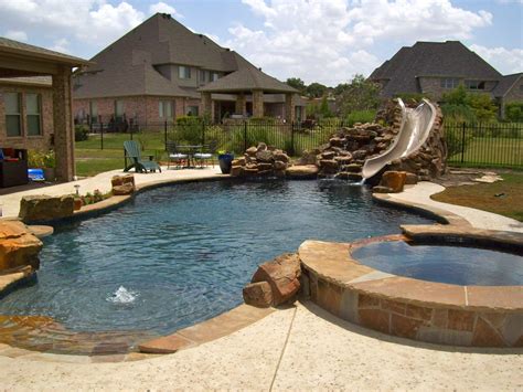 A Backyard With A Pool And Slide In The Middle