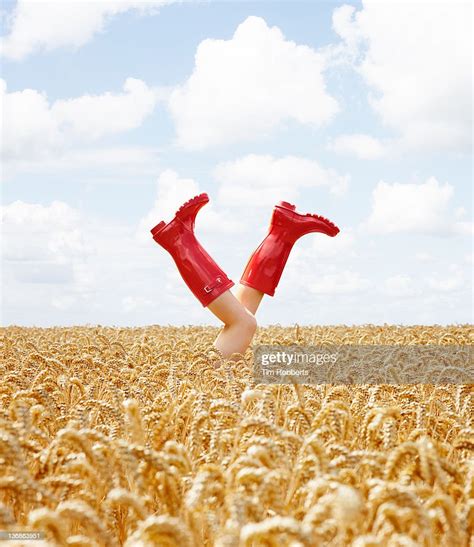 Young Woman With Her Legs In The Air In Crop Field Photo Getty Images