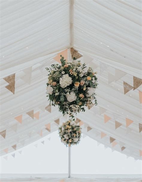 hanging flowers are perfect for a marquee wedding filling the roof space with colour and a bit