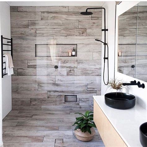 Tiling a shower is an advanced project, but it can be done by any experienced diyer with the right approach and information. Washed timber tiled feature wall with niche and floor with ...