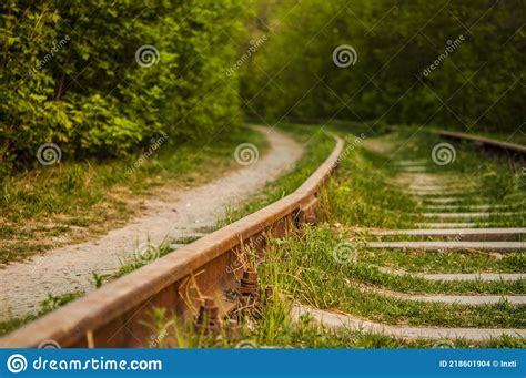 Abandoned Railroad With Rusty Rails And Rotten Wooden Sleepers In The