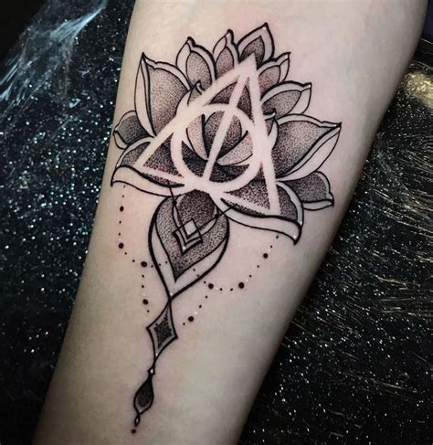 A Black And White Tattoo With A Flower On The Arm In Front Of A Dark