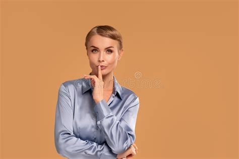 Beauty Blonde Woman With Short Hairstyle Holding Finger At Lips Showing Silence Sign