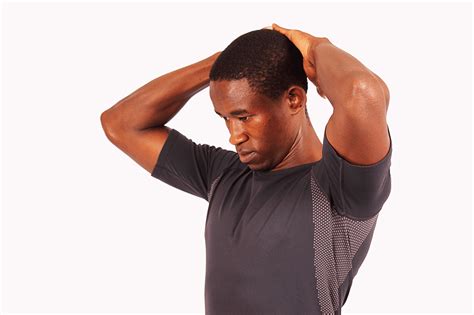 Young Man Stretching Neck Forward To Relieve Neck Pain