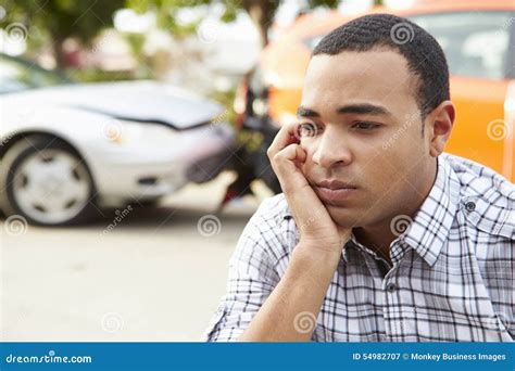 Worried Male Driver Sitting By Car After Traffic Accident Stock Image