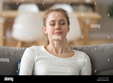 Close Up Calm Peaceful Woman Relaxing With Closed Eyes On Sofa Stock