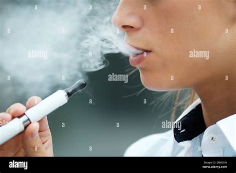 Closeup Of Woman Smoking E Cigarette And Enjoying Smoke Copy Space