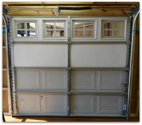 Adhere insulation to garage door — open your adhesive and start adhering your cut insulation to the door. Plano Garage Door Showroom | New Garage Door Installation