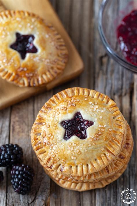 Two Small Pies With Blueberries And Raspberry Jam On Top