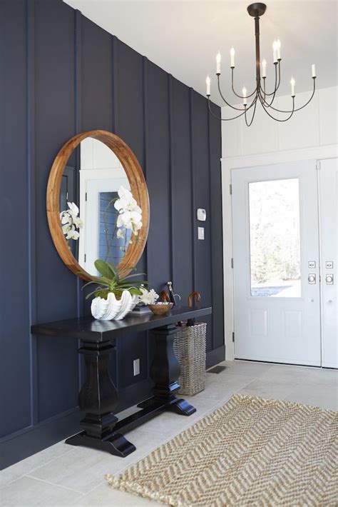 Wall Panelling And A Navy Blue Hue Brings Character To This Entryway
