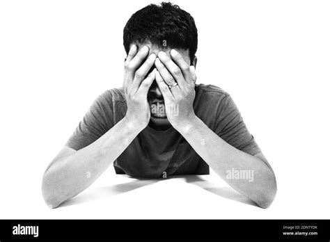 Depressed Man Sitting Against White Background Stock Photo Alamy