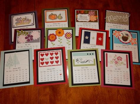 Many Different Cards Are Arranged On A Wooden Table With The Calendars