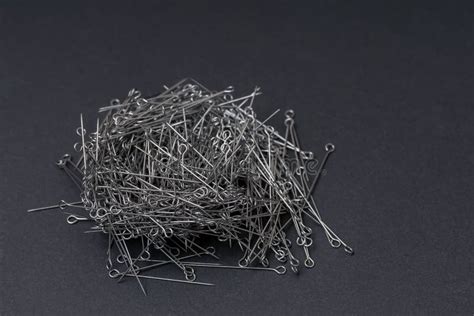 A Pile Of Safety Pins Lies On The Black Paper Stock Photo Image Of