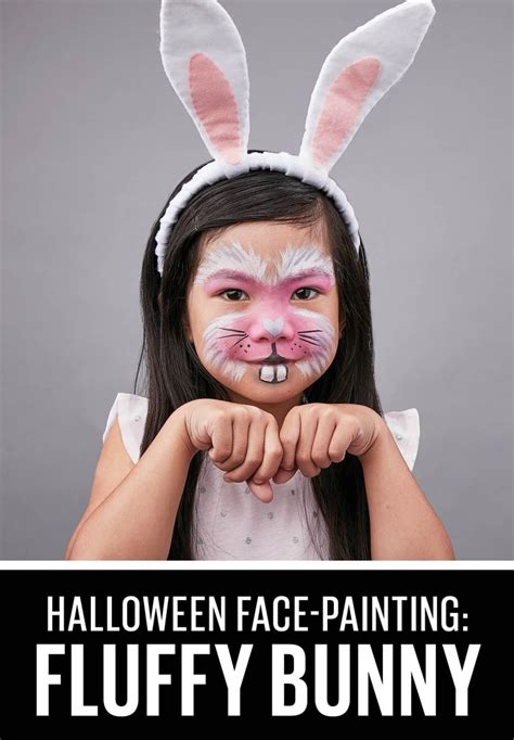 A Girl With Bunny Ears Painted On Her Face And The Words Halloween