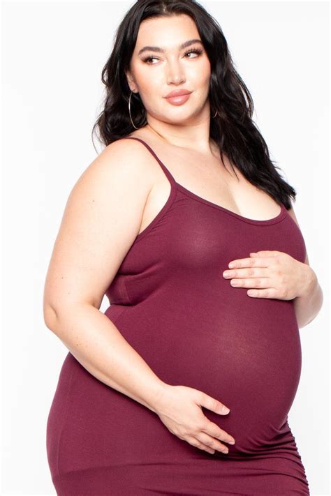 This Plus Size Maternity Stretch Knit Dress Features A Scoop Neckline