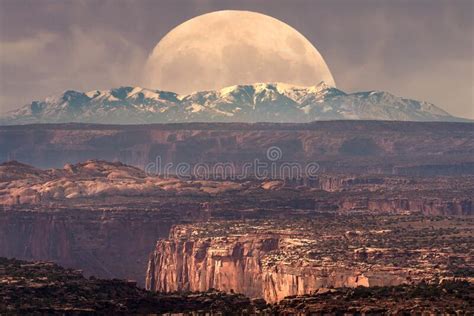 Full Moon Rising Behind La Sal Mountains In Canyonlands National Park