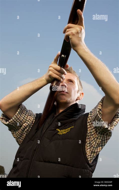 Man Holding Shotgun In Firing Position Stock Photo Alamy