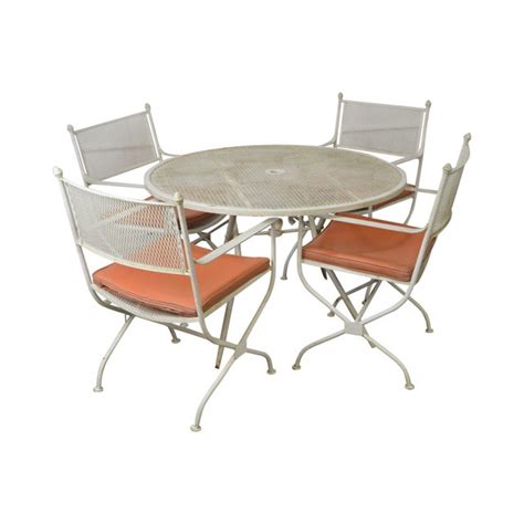 Our largest twelve foot version sits up to twelve adults and has a third, middle leg, as seen in the photo above. Salterini Mid-Century Expanded Metal Wrought Iron Round Patio Table & 4 Chairs | Chairish