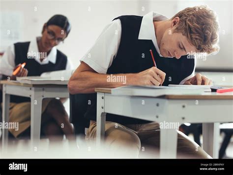 Teenage Boy School Uniform Writing High Resolution Stock Photography