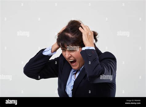 Mature Businesswoman Having A Nervous Breakdown Isolated On Gray