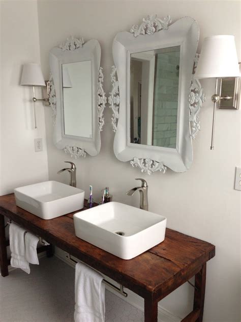 A double sink bathroom vanity with makeup table gives the space a further function. White bathroom with vessel sinks and wood table as vanity ...