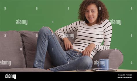 Millennial Black Woman Relaxing On Sofa Green Screen Stock Photo Alamy