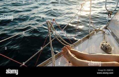 Female Legs Feet On The Sailing Yacht Closeup In The Open Sea Stock