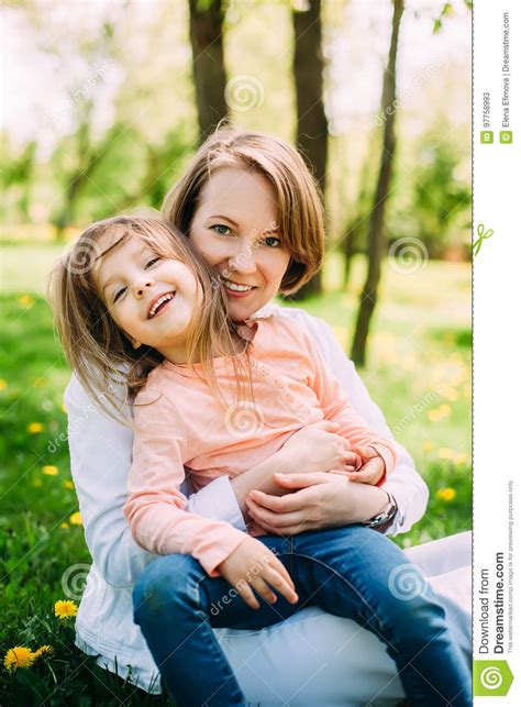 Hugging Happy Mother And Daughter For A Walk In The Park On The Green Lawn Stock Image Image
