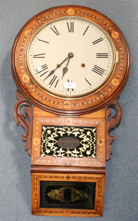 A Late 19th Century American Walnut Drop Dial Wall Clock With Eight Day Movement Striking On A Bell
