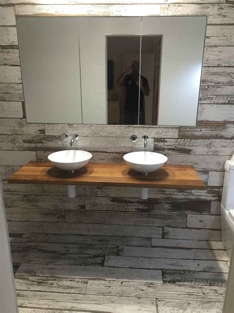 The main bathroom housed a freestanding bath, with a floating wash plane basin housing cabinetry underneath and a mirrored cabinet with strip lighting behind tatjana plitt small contemporary master bathroom in melbourne with a freestanding tub, an open shower, gray tile, marble, porcelain floors. Private residence in Brisbane given the shabby chic look ...