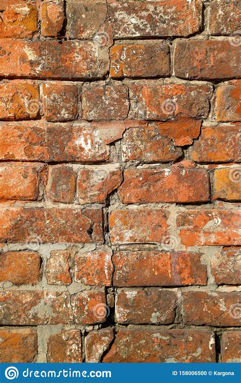 Texture Of An Old Damaged Brick Wall With A Big Crack In It Stock Photo