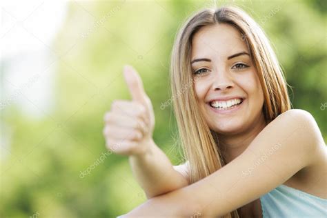Happy Young Woman Showing Thumbs Up Sign Stock Photo By ©stokkete 12866006