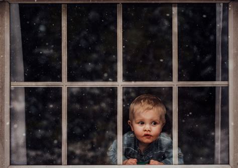 Small Boy Child Looking Out Window At Snow Falling Meg Loeks Click