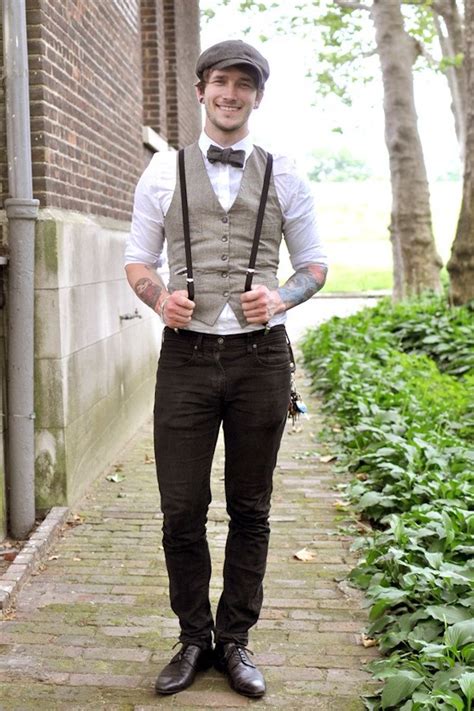 Trousers In Black Worn With Suspenders A White Shirt And A Beige Vest