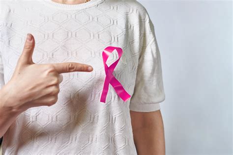 A Pink Badge Ribbon On Woman Chest To Support Breast Cancer Cause Creative Commons Bilder