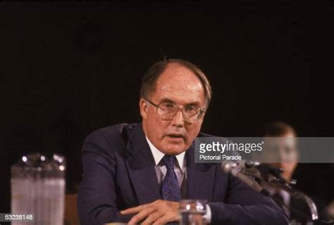 American Jurist William Rehnquist Sits Behind A Microphone As He