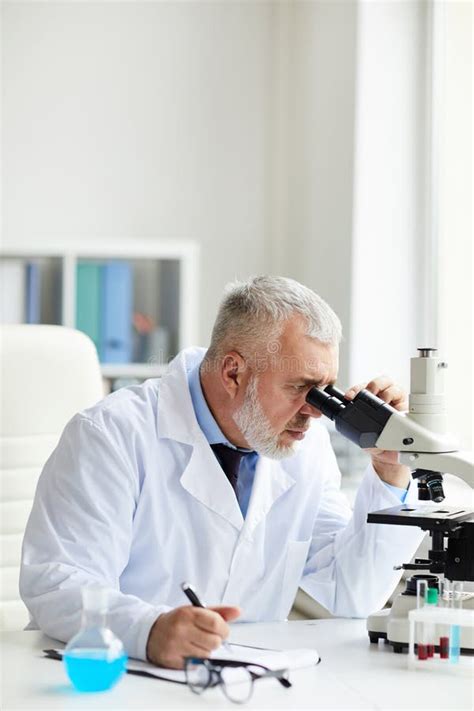 Scientist Working With Microscope At The Lab Stock Photo Image Of