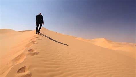 Man Walking In The Desert Stock Footage Video Shutterstock