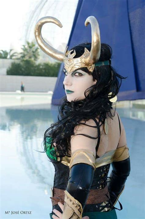 A Woman Dressed In Costume Standing Next To A Swimming Pool With Horns